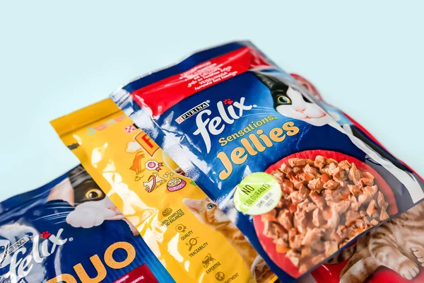 Cat food. Animal feed in portion bags on a light blue background. Kyiv. Ukraine. April 25, 2022