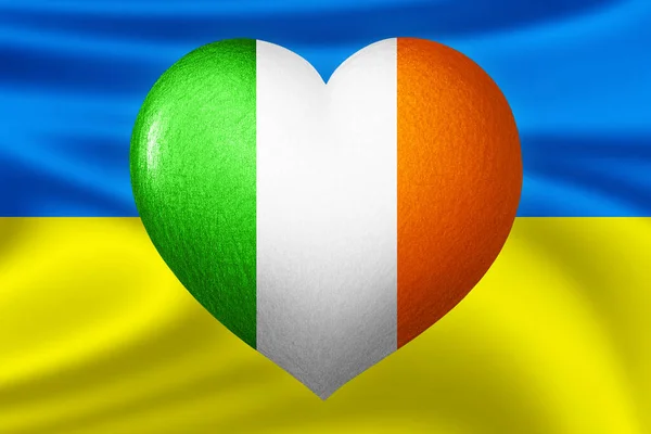 Flags of Ukraine and Ireland. Heart color of the flag on the background of the flag of Ukraine. The concept of protection and solidarity. Military and humanitarian assistance.
