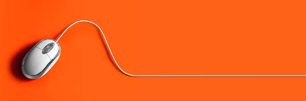 Computer mouse on an orange background. Mouse with cable. Background for web design.