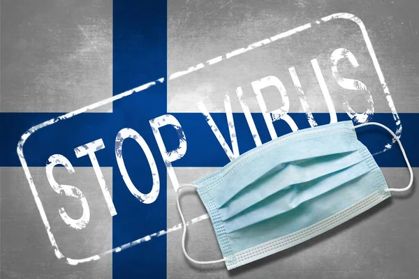 Lettering stamp Stop Virus and medical mask on Finland flag. Return of the coronavirus. New jump in incidence. Strain Omicron and Dedta. Danger of a viral infection. Medical concept.