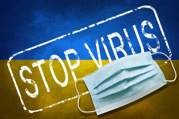 Lettering stamp Stop Virus and medical mask on Ukraine flag. Return of the coronavirus. New jump in incidence. Strain Omicron and Dedta. Danger of a viral infection. Medical concept.