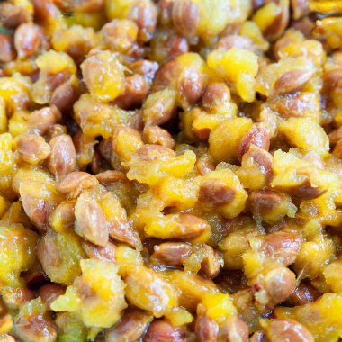 Plum pits background. Close-up of a lot of red cherry plum stones. Abstract creative surface for design