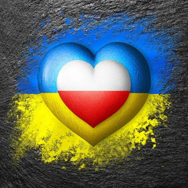 Flags of Ukraine and Poland. Two hearts in the colors of the flags are painted on the stone. Concept of protection, solidarity, cooperation and assistance of countries