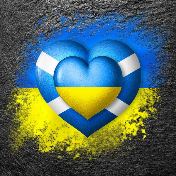 Flags of Ukraine and Scotland. Two hearts in the colors of the flags on the flag of Ukraine painted on stone. Protection, solidarity and help concept. Cooperation of countries.