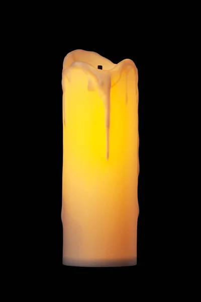 Electric candle. Lamp in the shape of a large candle isolated on a black background
