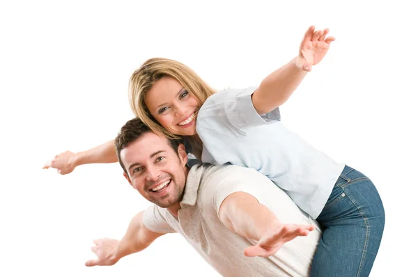 Happy smiling couple piggyback arms outstretched Stock Image