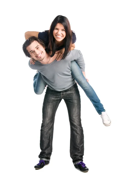 Happy couple playing piggyback together Stock Photo