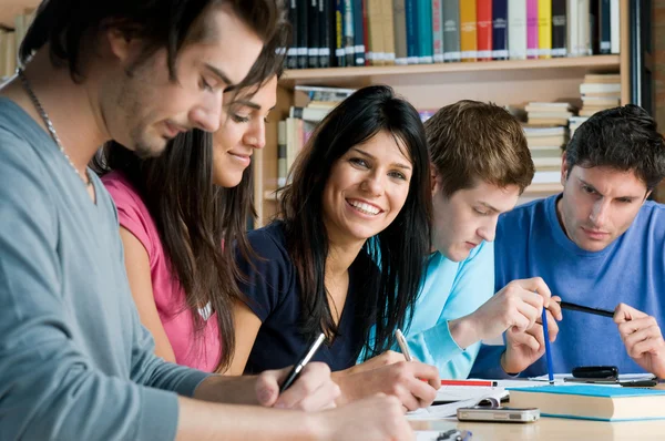 Young students studying in a library — Stock Photo, Image