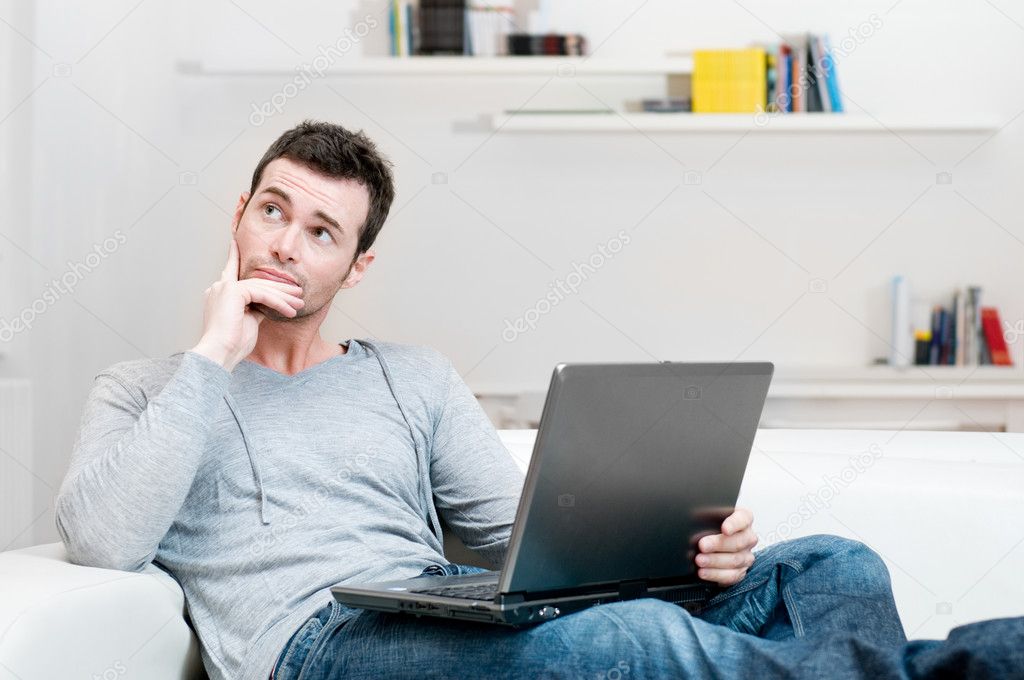 Absorbed and confused man on laptop