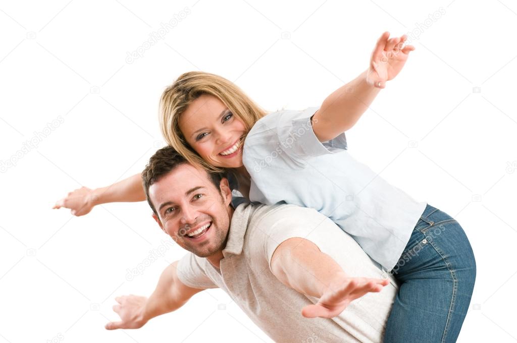Happy smiling couple piggyback arms outstretched