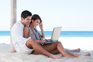 Summer couple using laptop clipart