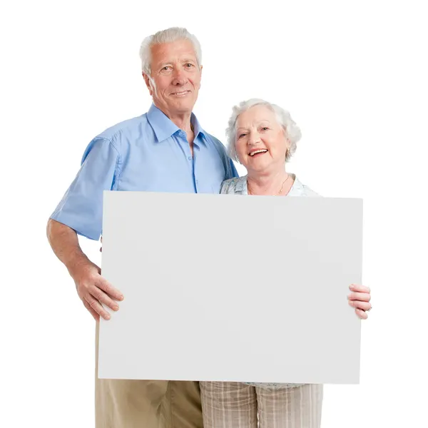 Happy loving couple with sign — Stock Photo, Image