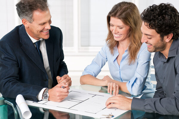 Estate agent with smiling couple