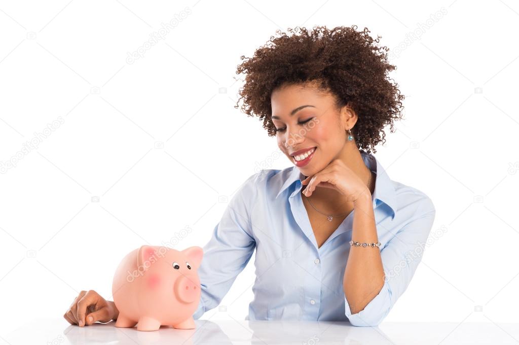 Businesswoman Looking At Piggybank