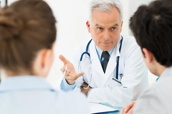 Médico discutindo com pacientes — Fotografia de Stock