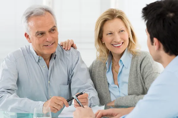 Senior Couple Talking With A Consultant