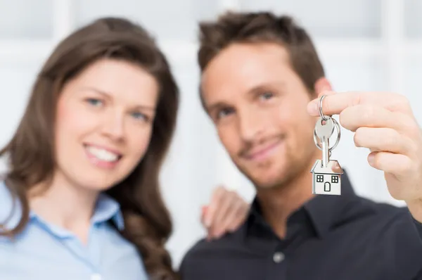 Young Couple Showing Keys Of New House Stock Picture
