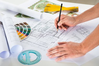 Draftsman Drawing Plan On Blueprint clipart