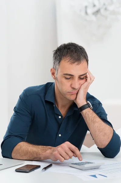 Hombre cansado haciendo cálculos —  Fotos de Stock