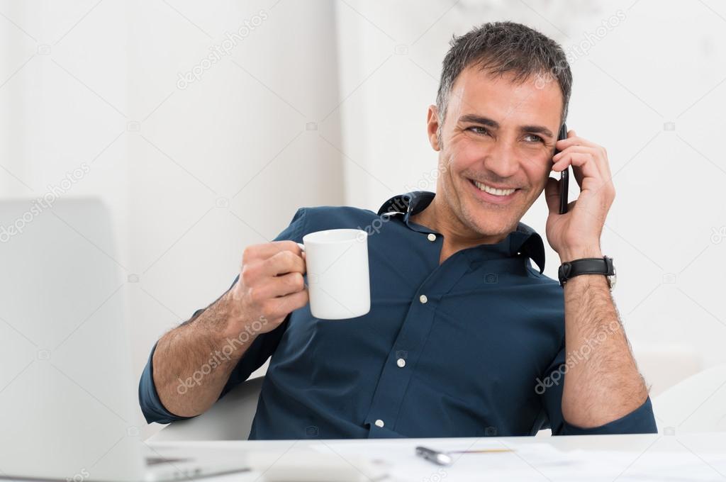 Happy Mature Man Talking On Cellphone