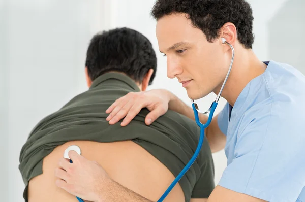 Doctor escuchando los pulmones del paciente — Foto de Stock