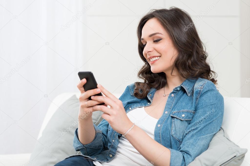 Smiling Young Woman Holding Cellphone