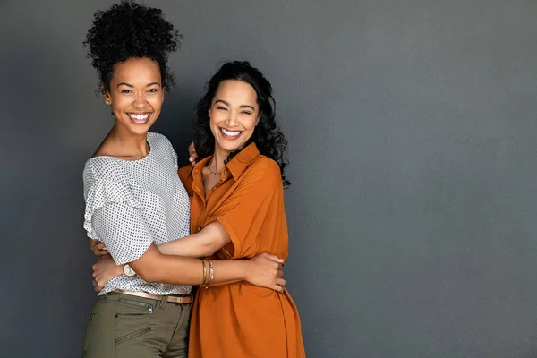 Retrato Mujeres Felices Abrazándose Unas Otras Contra Pared Gris Con — Foto de Stock