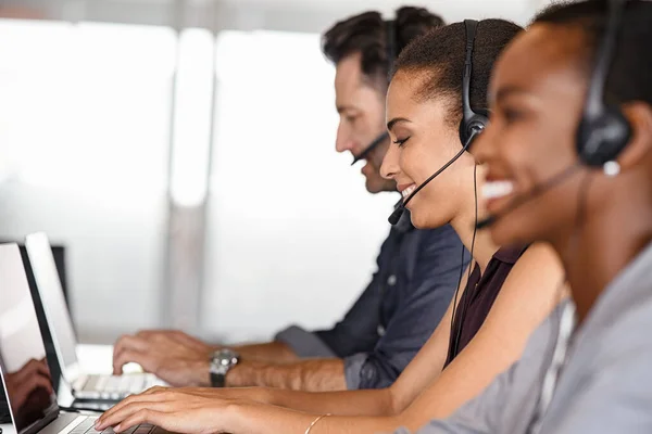 Smiling Multiethnic People Headsets Using Computer Smiling While Working Office — Foto de Stock