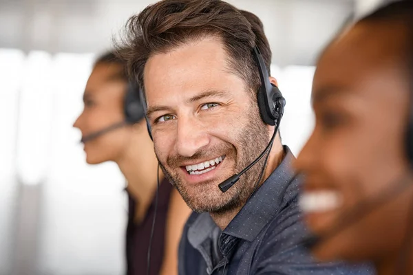 Portrait Smiling Customer Service Executive Headset Sitting Team Attending Calls — Zdjęcie stockowe