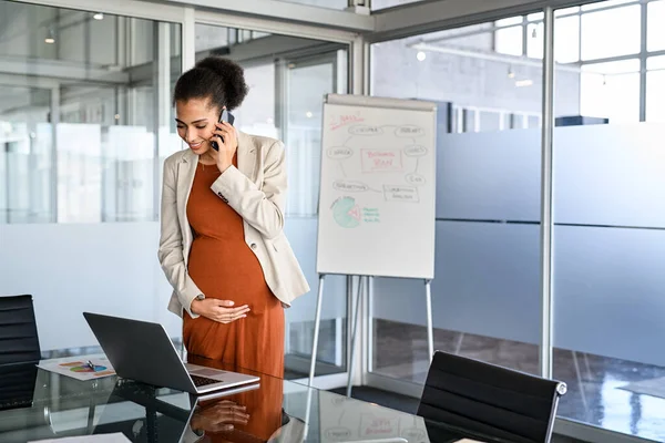 Smiling Pregnant Businesswoman Touching Belly While Using Laptop Talking Phone — Zdjęcie stockowe