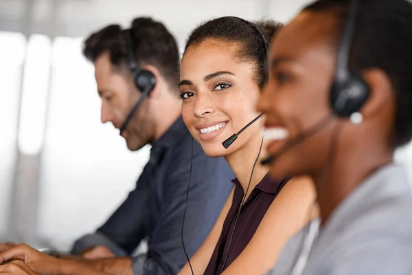 Portrait Smiling Customer Service Operator Headset Sitting Colleagues Attending Calls Stock Fotografie