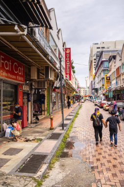 Sandakan, Malezya - 06 Ocak 2022: Borneo 'da şehir manzarası. Köhne evler ve sokaktaki eski Malezya arabaları. Sabah 'ın ikinci büyük şehri ve eskiden Elopura olarak biliniyor. Şehir manzaralı Sandakan