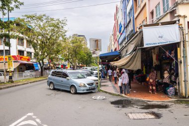 Sandakan, Malaysia - January 06, 2022: Cityscape of the Borneo town. Rundown houses and old Malaysian cars on the street. Second largest city of Sabah and formerly known as Elopura. City view Sandakan