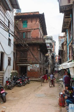 Kathmandu, Nepal - October 27, 2021: Cityscape of the Nepalese capital. An dusty road in the capital, poor conditions in the streets of Nepal. Cityscape or street view. provisionally laid power cables