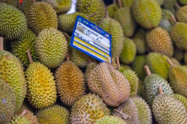 Malezya 'nın başkenti Kuala Lumpur' da taze bir pazarda bir yığın durian. Güçlü kokulu meyve, dikenli derisi ve sarı posası. Durian geleneksel olarak Malezya veya Endonezya 'dan gelir.