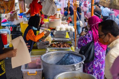Kuala Lumpur, Malezya - 21 Haziran 2022: Asya metropolündeki bir sokak yiyecek pazarında. Köri pilavı, tavuk pilavı ve küçük tezgahlarda daha popüler Asya yemekleri satılıyor..