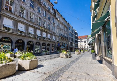 Munich, Germany - July 6, 2022: Along Perusastrasse, the extension of Maximilianstrasse with no less expensive shops. Prada and some jewelers are based here. Car free pedestrian zone