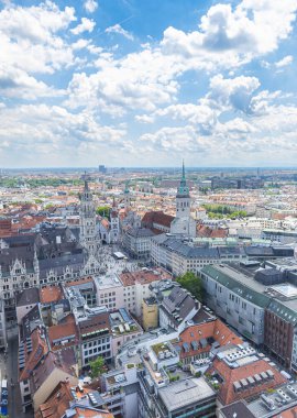 Münih, Almanya - 6 Temmuz 2022: Mnchen gökdeleninin görüntüsü, Muenchner Dom veya Frauenkirche 'in iki kulesinden birinin havadan görüntüsü. Mavi gökyüzü ve beyaz bulutlar ufka dokunuyor.