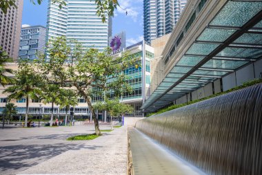 Kuala Lumpur, Malaysia - August 13, 2022: KLCC Park with the water fountain show in front of the Petronas towers. HDR Long exposure with silky water jet. City oasis around the twin towers Suria KLCC