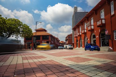Malacca, Malaysia - August 10, 2022: Long Exposure capture of the red square or Dutch square in the city of Melaka. Passing cars as visible as a veil. Low angle panoramic view of the street