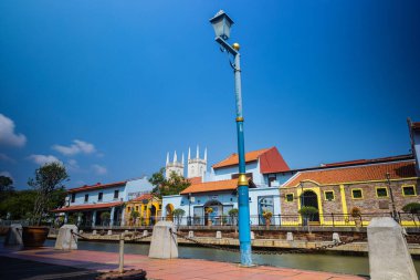 Malacca, Malaysia - August 10, 2022: Along the Melaka river with the old brightly painted houses. Bars and restaurants line the course of the river. Long Exposure capture smooths silky water.
