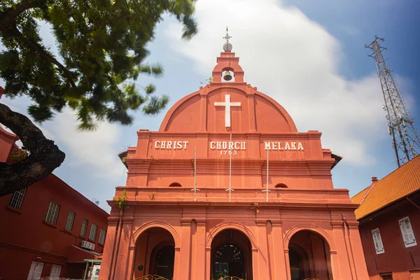 Malacca, Malaysia - August 10, 2022: Christ Church in. The center of Melaka. The oldest functioning Protestant church in Malaysia. Silky clouds with long exposure. Front view from the Dutch square