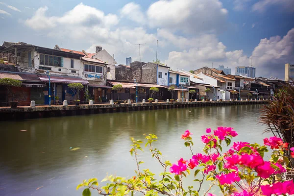 Malacca, Malaysia - August 10, 2022: Along the Melaka river with the old brightly painted houses. Bars and restaurants line the course of the river. Long Exposure capture smooths silky water.