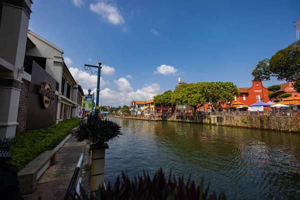 Malacca, Malaysia - August 10, 2022: Along the Melaka river with the old brightly painted houses. Bars and restaurants line the course of the river. Long Exposure capture smooths silky water.