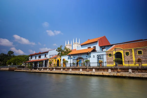 Malacca, Malaysia - August 10, 2022: Along the Melaka river with the old brightly painted houses. Bars and restaurants line the course of the river. Long Exposure capture smooths silky water.