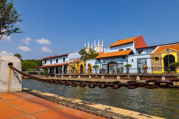 Malacca, Malaysia - August 10, 2022: Along the Melaka river with the old brightly painted houses. Bars and restaurants line the course of the river. Long Exposure capture smooths silky water.