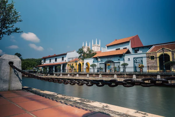 Malacca, Malaysia - August 10, 2022: Along the Melaka river with the old brightly painted houses. Bars and restaurants line the course of the river. Long Exposure capture smooths silky water.