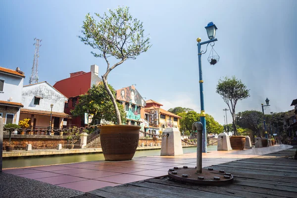 Malacca, Malaysia - August 10, 2022: Along the Melaka river with the old brightly painted houses. Bars and restaurants line the course of the river. Long Exposure capture smooths silky water.