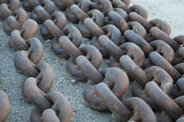 Ships anchor chain on the sand Stock Picture