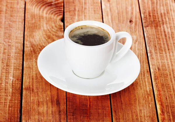 Coffee cup and saucer on a wooden background. — Stock Photo, Image